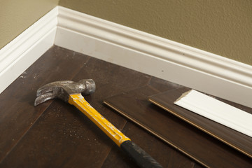 Hammer, Laminate Flooring and New Baseboard Molding