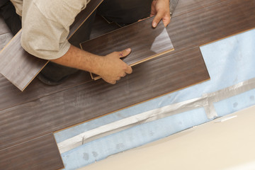 Man Installing New Laminate Wood Flooring