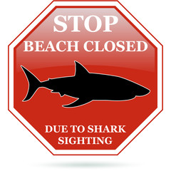 Beach closed due to shark sighting red sign.