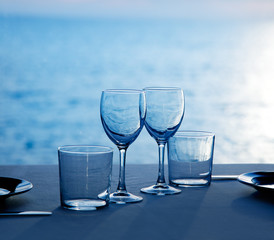 Glass dish cups and glasses on blue sea