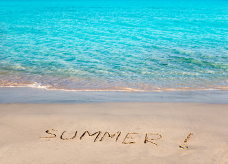 Tropical beach with Summer word written in sand