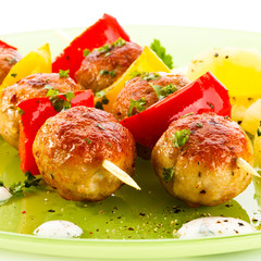 Grilled meat and vegetables on white background