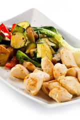 Grilled meat and vegetables on white background