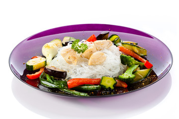 Roasted meat, rice noodles and vegetables on white background