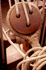 Ancient wooden sailboat pulleys and ropes