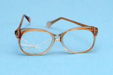 retro galsses with broken glass blue background