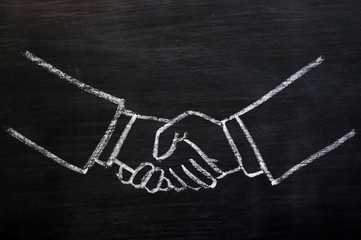 Chalk drawing of handshaking on a blackboard