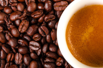 Coffee cup on coffee beans