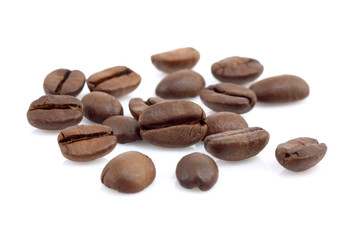 Heap of coffee beans at white background