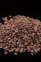Heap of coffee beans at black background