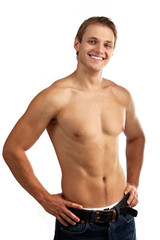 Cheerful young man in jeans with bare torso