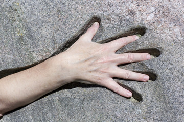 Hand and granite stone