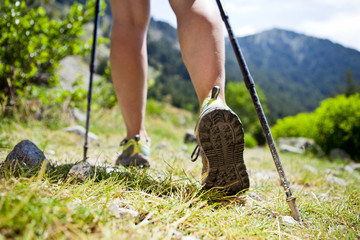 Nordic walking legs in mountains - Powered by Adobe