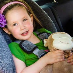 close-up of pretty little girl safe in her car seat - 42630419