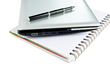 Laptop and Black pen put on White Book