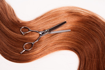 straight healthy woman hair and scissors