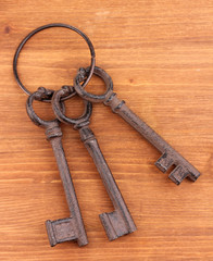 a bunch of antique keys on wooden background