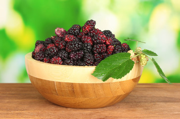 Wooden bowl with ripe mulberries