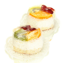 sweet cakes with fruits isolated on white