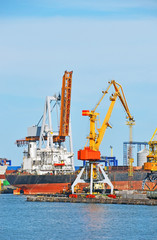 Container stack and ship under crane bridge