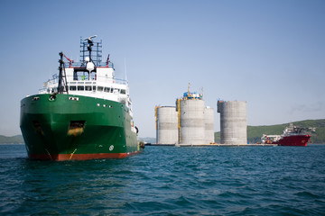 tugs towing base offshore oil platform