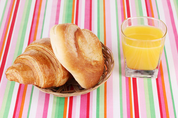 Classical breakfast. Orange juice with bun and croissant