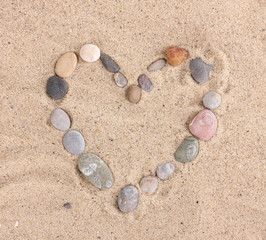 Fototapeta na wymiar Love-stones on sand