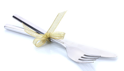 Silver fork and knife tied with ribbon isolated on white