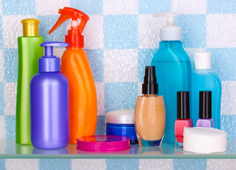 Shelf with cosmetics and toiletries in bathroom