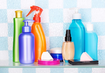 Shelf with cosmetics and toiletries in bathroom