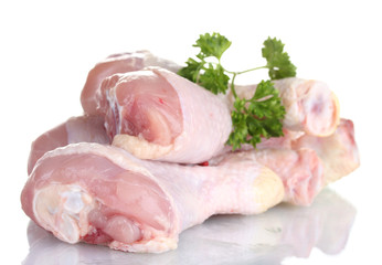 Raw Chicken Drumsticks in plate with parsley isolated on white