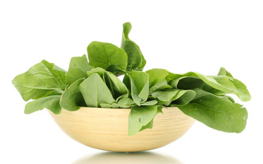 Fresh spinach in wooden bowl isolated on white