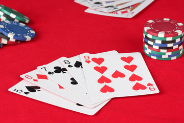 The red poker table with playing cards. The combination of