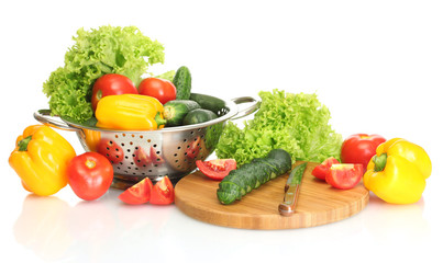 fresh vegetables and knife on cutting board isolated on white