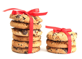 Chocolate chips cookies with red ribbons isolated on white.