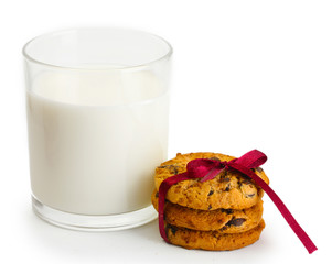glass of milk and chocolate chips cookies with red ribbon
