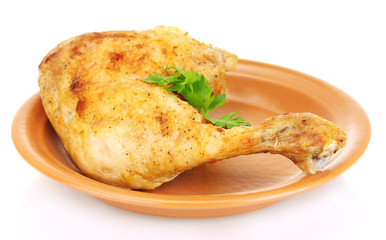 roasted chicken leg with parsley in the plate isolated on white