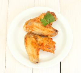 roasted chicken wings with parsley in the plate