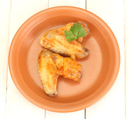 roasted chicken wings with parsley in the plate