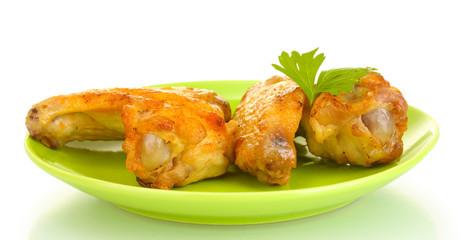 roasted chicken wings with parsley in the plate isolated