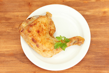 roasted chicken leg with parsley in the plate