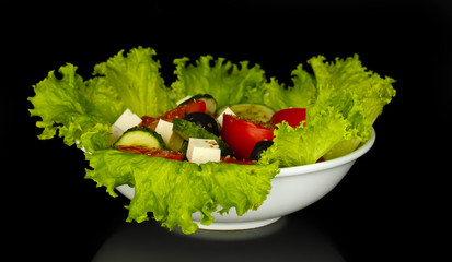 tasty greek salad isolated on black