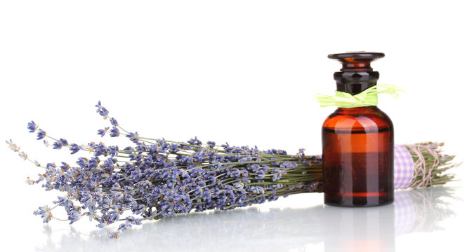 Lavender flowers and glass bottle isolated on white