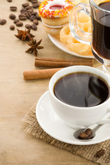 cup of coffee with beans and sweets