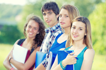 Fototapeta na wymiar Portrait happy young students in park