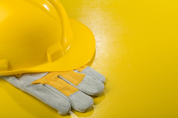 yellow hardhat on glove