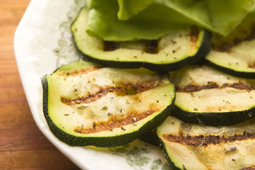 Grilled organic zucchini slices with herbs and spices
