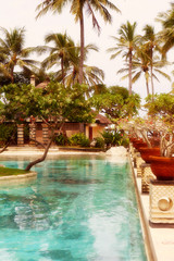 Fototapeta premium Palm trees near pool in tropics