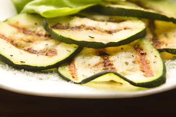 Grilled organic zucchini slices with herbs and spices