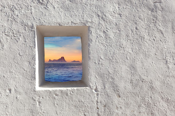 Balearic islands Es Vedra sunset through window